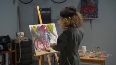 Woman looks at her picture and throws it away