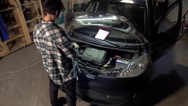 Mann zieht Handschuhe in der Garage an — Stockvideo