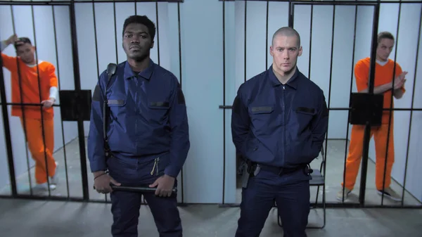 Guards stand in the background of prison cells — Stock Photo, Image