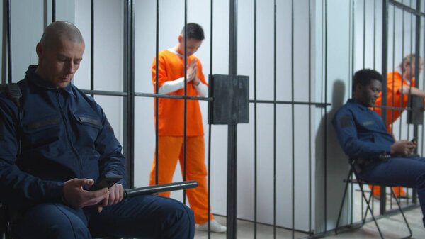 Two jailers at a post in prison. View