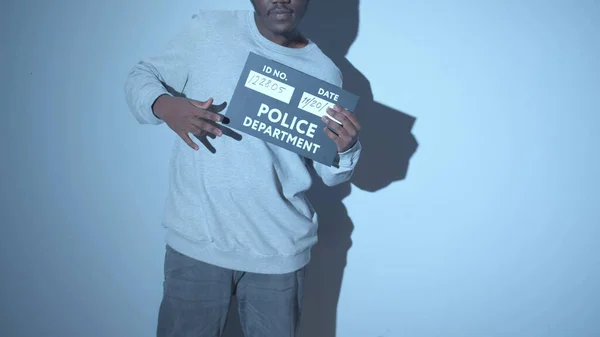 Gangster poses for a photo at the police station — Stock Photo, Image