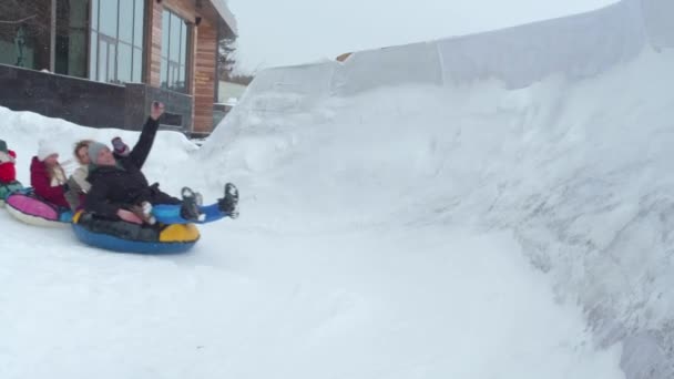 Mamma pappa och barn rida en slang på vintern — Stockvideo