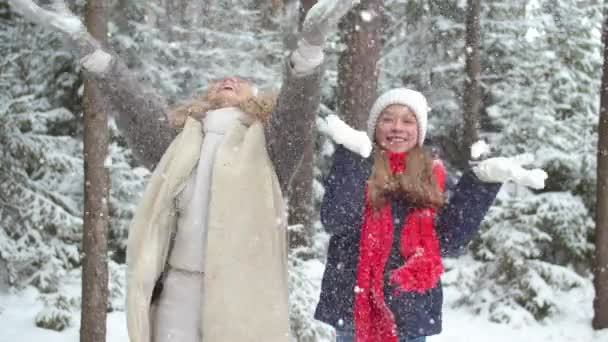 Η μαμά και η κόρη ρίχνουν χιόνι πάνω τους. — Αρχείο Βίντεο