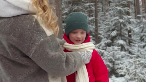 Loving mom puts a scarf on her son. Medium shot — Stock Video