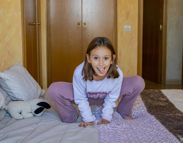 Girl jumping on the bed — Stock Photo, Image