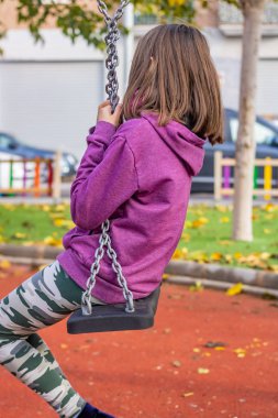 Park yerinde poz veren küçük kız.