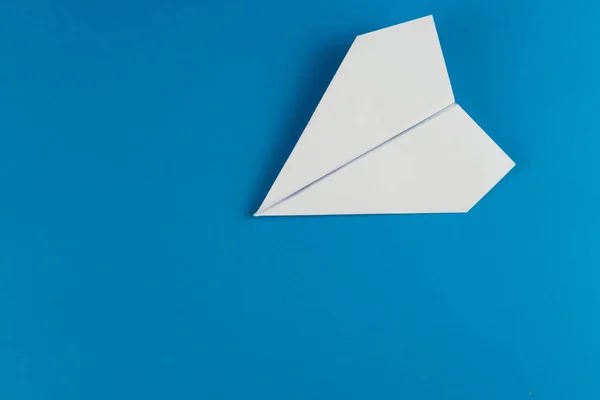 Handmade white paper plane on blue background — Stock Photo, Image