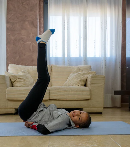 Niña Haciendo Deportes Sala Estar Casa Una Alfombra Azul — Foto de Stock