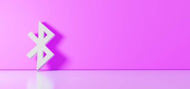 Bluetooth simgesinin 3d görüntülemesi sağ tarafında boş alan olan yer yansıması ile renk duvarına yaslanıyor
