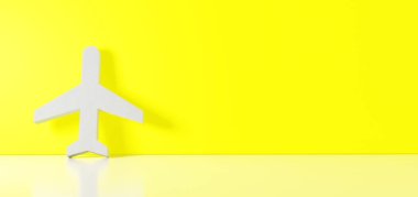 Uçuş simgesinin üç boyutlu görüntülemesi sağ tarafında boş alan olan zemin yansıması ile renk duvarına yaslanıyor