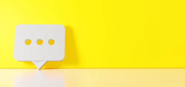 3D vykreslování bílého symbolu zaoblené bubliny chatu ikony opírající se o barevnou stěnu s odleskem podlahy s prázdným prostorem na pravé straně — Stock fotografie