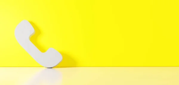3D-återgivning av vit symbol för kommunikation telefon ikon lutar sig mot färg vägg med golv reflektion med tomt utrymme på höger sida — Stockfoto