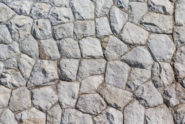 Taş bir duvarın dokusu. Eski kale taşından duvar dokusu. Bir taş duvarın parçası, arkaplan veya doku için