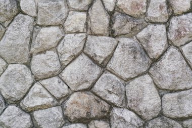 Taş bir duvarın dokusu. Eski kale taşından duvar dokusu. Bir taş duvarın parçası, arkaplan veya doku için
