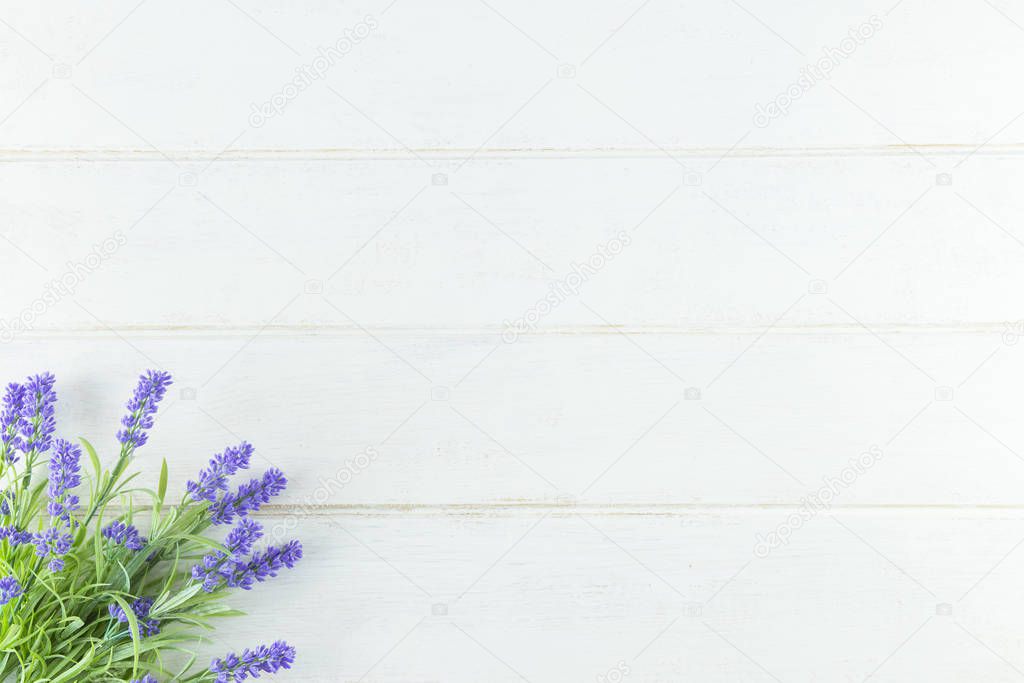 Violet Flowers of Lavender, top view on white Wooden background.