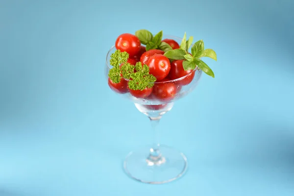 Cherry tomatoes in a cocktail glass.