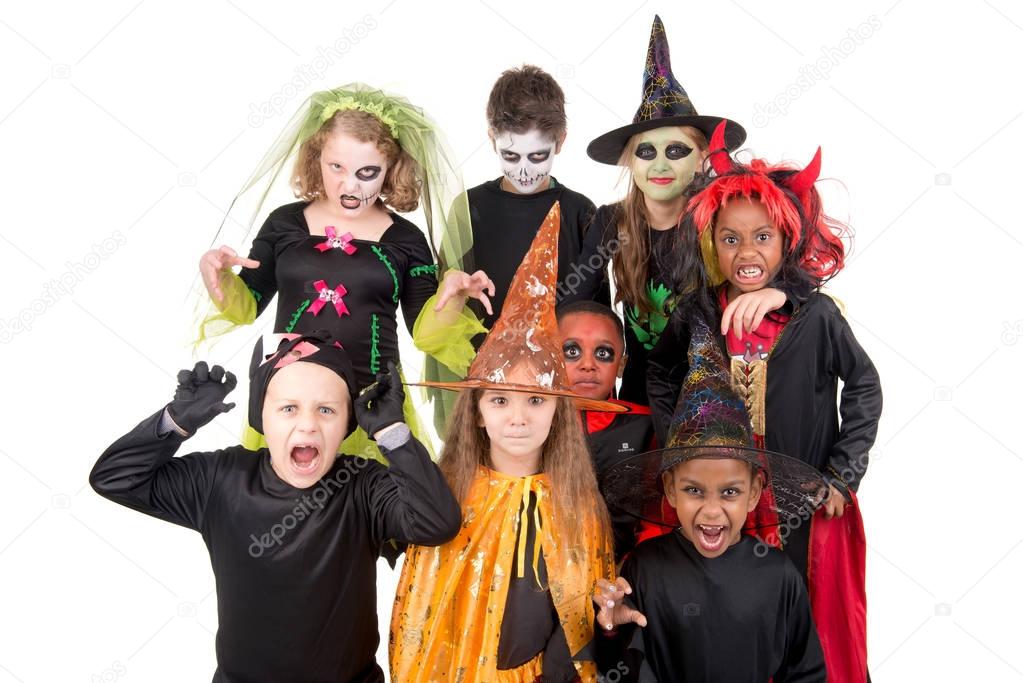 kids posing  in costumes for halloween 
