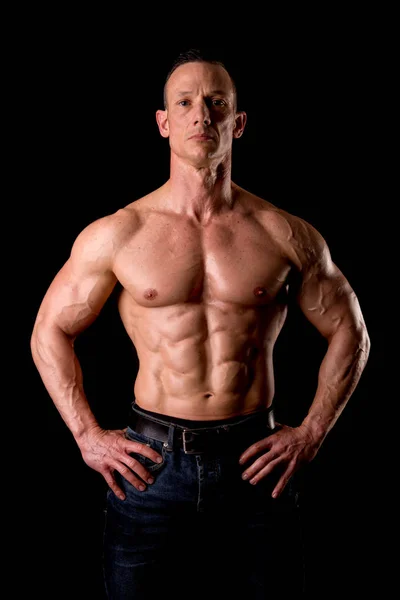 Athletic man showing muscles — Stock Photo, Image