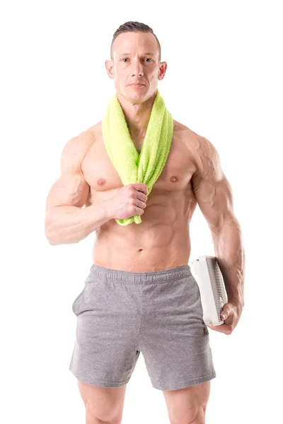 Muscular man holding scales — Stock Photo, Image