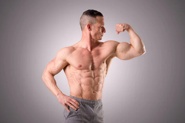 Athlete showing muscles — Stock Photo, Image
