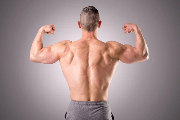 Athlete showing muscles — Stock Photo, Image