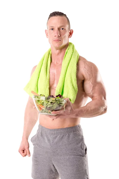 Homem muscular segurando tigela — Fotografia de Stock