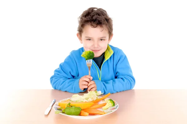 Boy eating vegetables — Stock Photo, Image