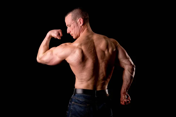 Athlete showing muscles — Stock Photo, Image