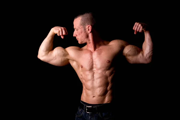 Athlete showing muscles — Stock Photo, Image