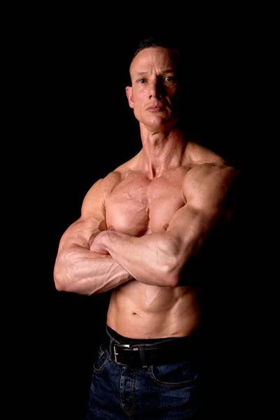 Athletic man showing muscles — Stock Photo, Image