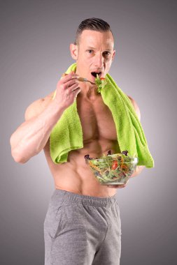 gri bir arka plan üzerinde poz uygun kaslı adam izole