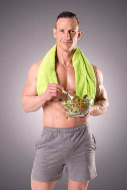 Kaslı adam holding salata