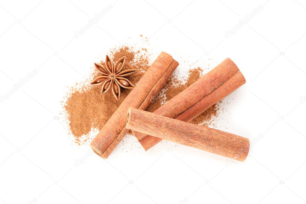 Cinnamon powder, sticks and anise isolated on white background