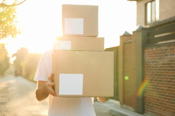 Leverancier houdt blanco dozen buiten, ruimte voor tekst — Stockfoto