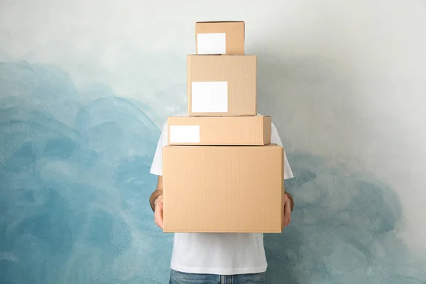 Man with blank boxes against blue background , space for text — Stock Photo, Image