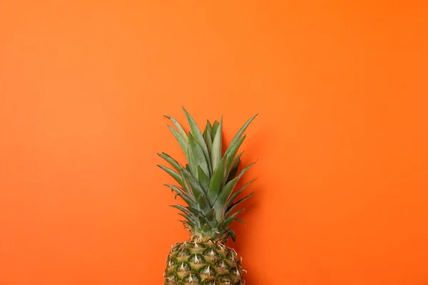 Bovenkant van ananas op oranje achtergrond, ruimte voor tekst. Sappig van smaak — Stockfoto