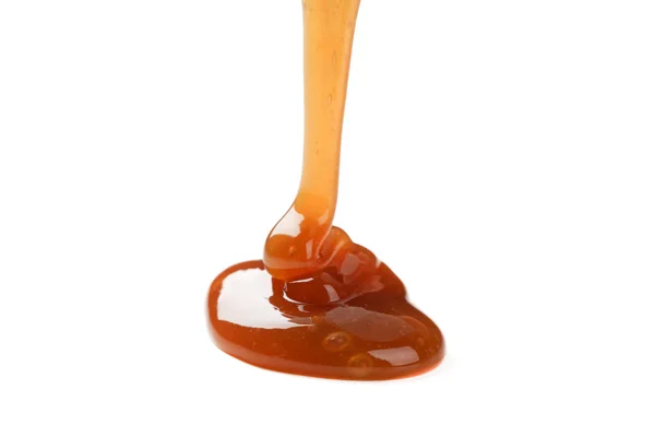 Pouring brown caramel isolated on white background — Stock Photo, Image