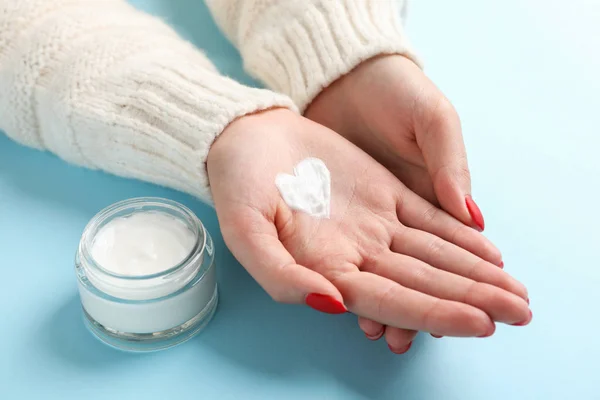 Woman hands, heart shape created from winter cream, jar of winte — Stock Photo, Image