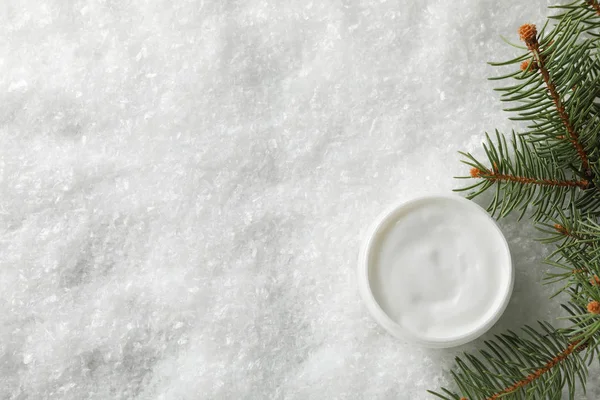 Jar of winter cream for skin on snowy background, space for text — Stock Photo, Image