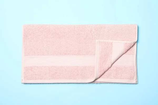 Pink towel on blue background, top view and close up — Stock Photo, Image