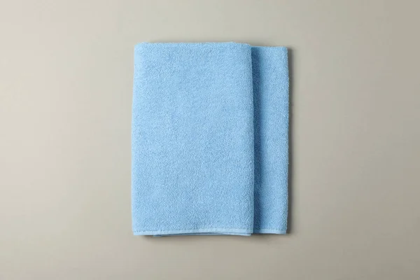 Fresh blue towel on grey background, top view — Stock Photo, Image