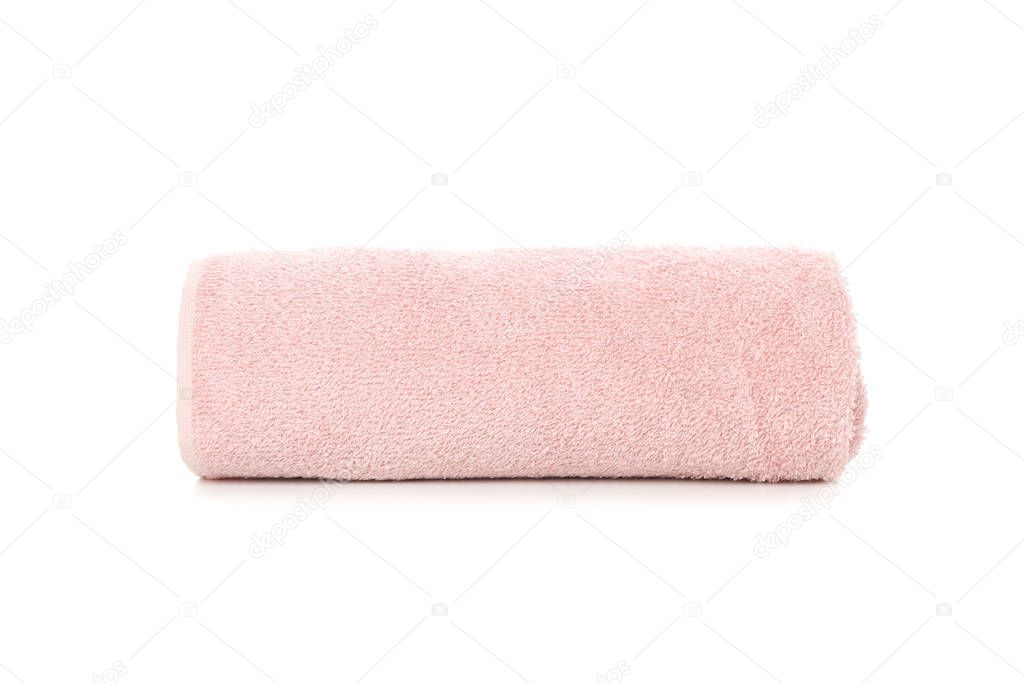Rolled pink towel isolated on white background, close up
