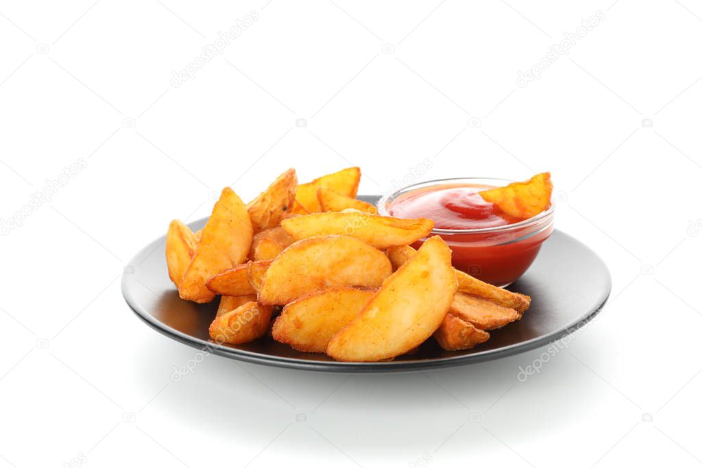 Plate with slices of baked potato wedges, red sauce isolated on 