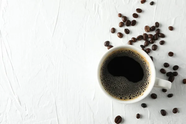 Tazza di caffè e fagioli su sfondo bianco, vista dall'alto — Foto Stock