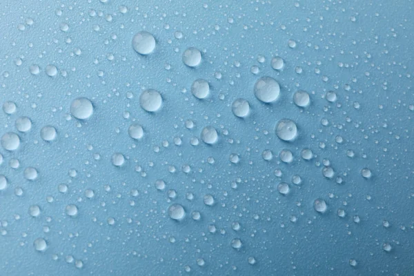 Many water drops on blue background. Texture background. — Stock Photo, Image