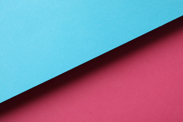 Two tone background made of sheets: blue and pink. Abstract back