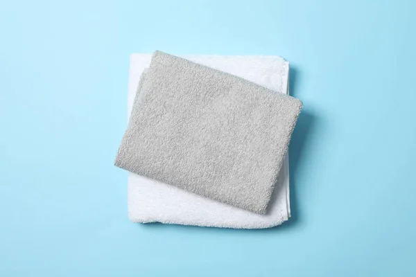 Gefaltete Handtücher auf blauem Hintergrund, Draufsicht und Platz für Text — Stockfoto