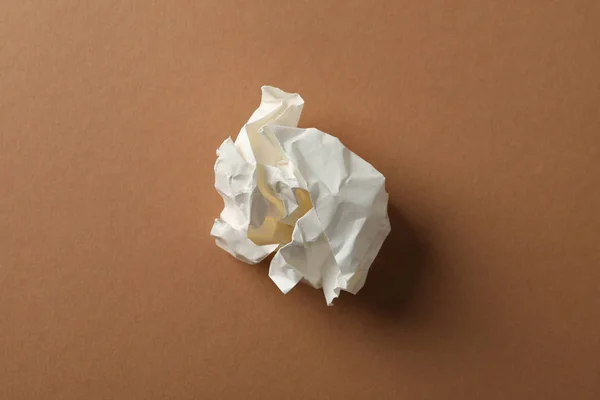 Paper ball on brown background, space for text — Stock Photo, Image