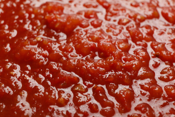 Chili sauce textured background, top view, closeup. Space for te