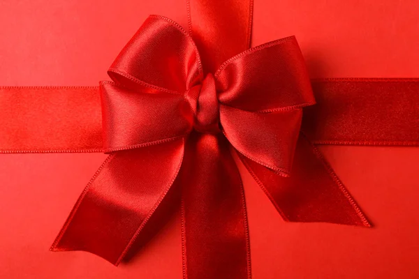 Red bow on red background, close up — 스톡 사진